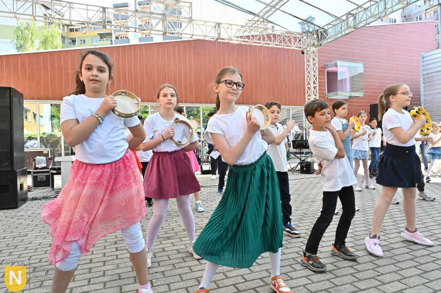 Girls in colorful skirts performing a dance with tambourines