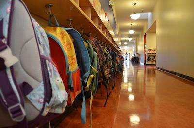 Backpacks in a K/1/2 hallway at Stanley