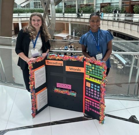 Two students pose with their project at the TAFE National Conference.