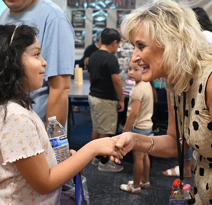 A Tempe Elementary teacher shaking hands with a student