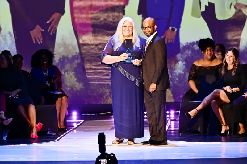 Dr. Pace center stage, presenting Griffis with the middle school TOTY award.