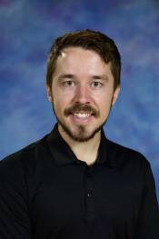 man with dark hair and black shirt