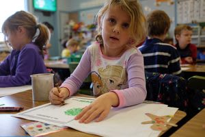 Little girl coloring in a classroom