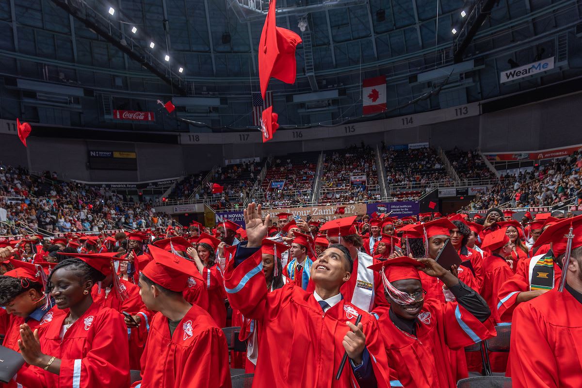Graduating students in red caps and gowns