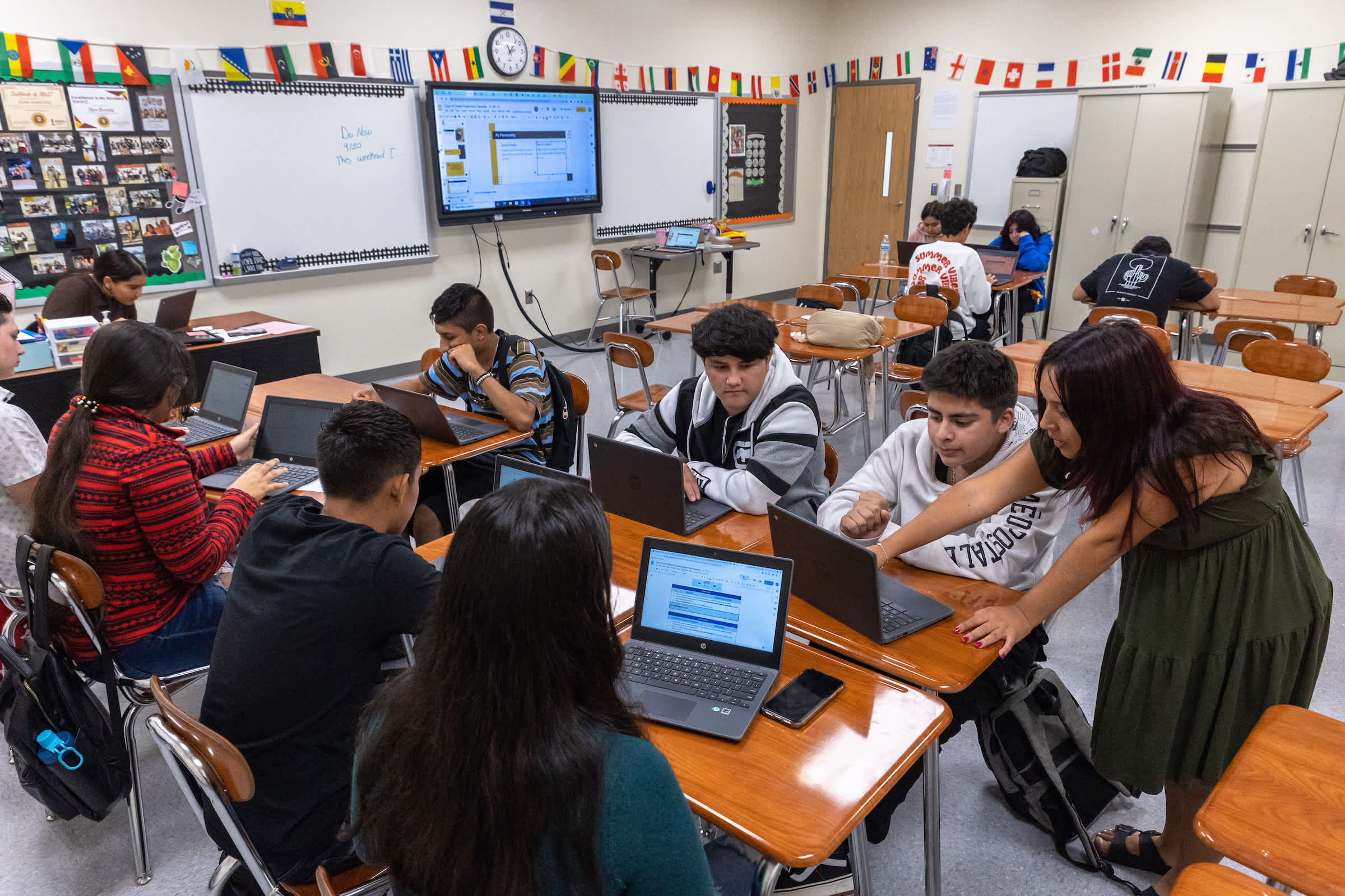 Students working on laptops in a modern classroom