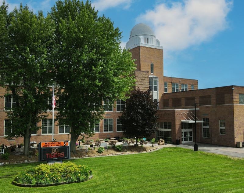 Marshfield Middle School entrance with large windows, tower, and school sign