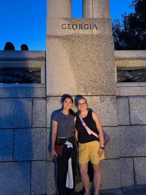 Student and teacher at column in remembrance of soldiers from Georgia