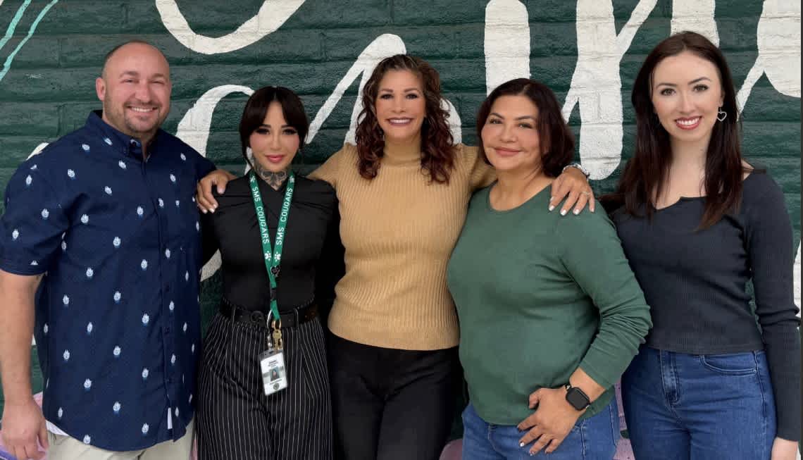 A group of counselors standing together at a school.