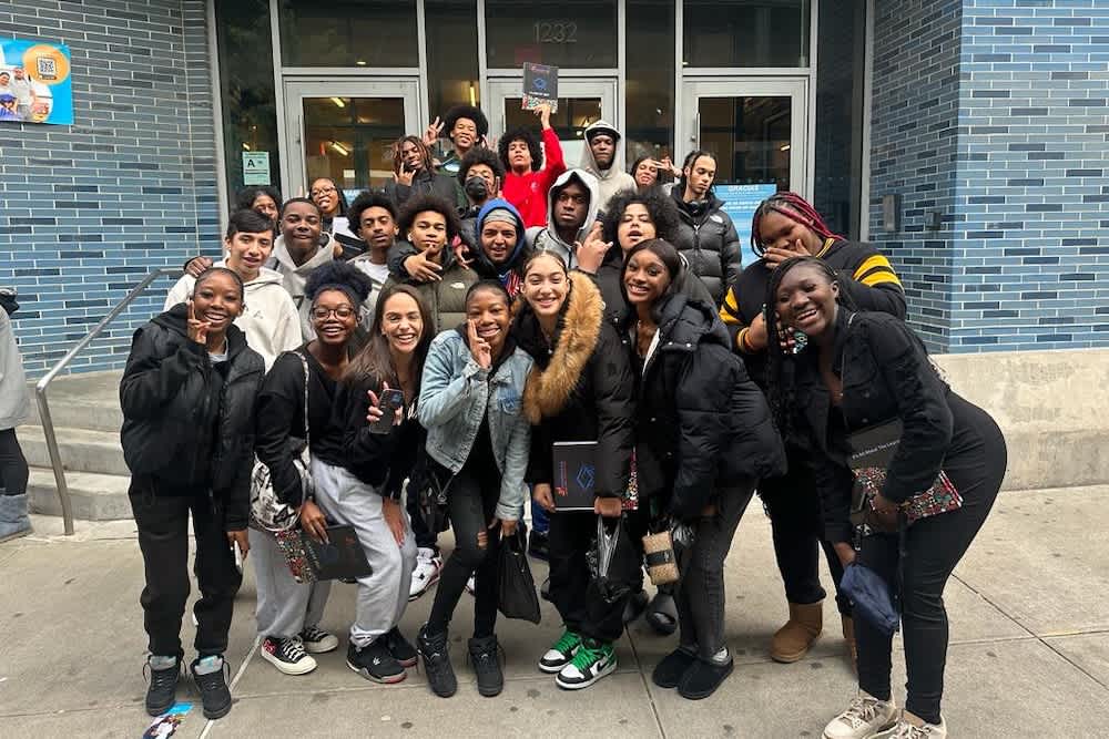 Alumni in front of their school