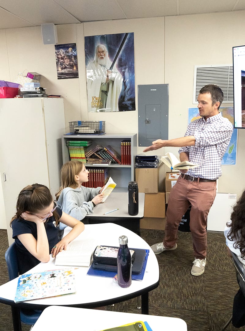 Teacher and two students engaged in a dynamic lesson