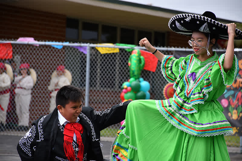 Two students in traditional attire performing during the Cinco De Mayo event at Willmore.
