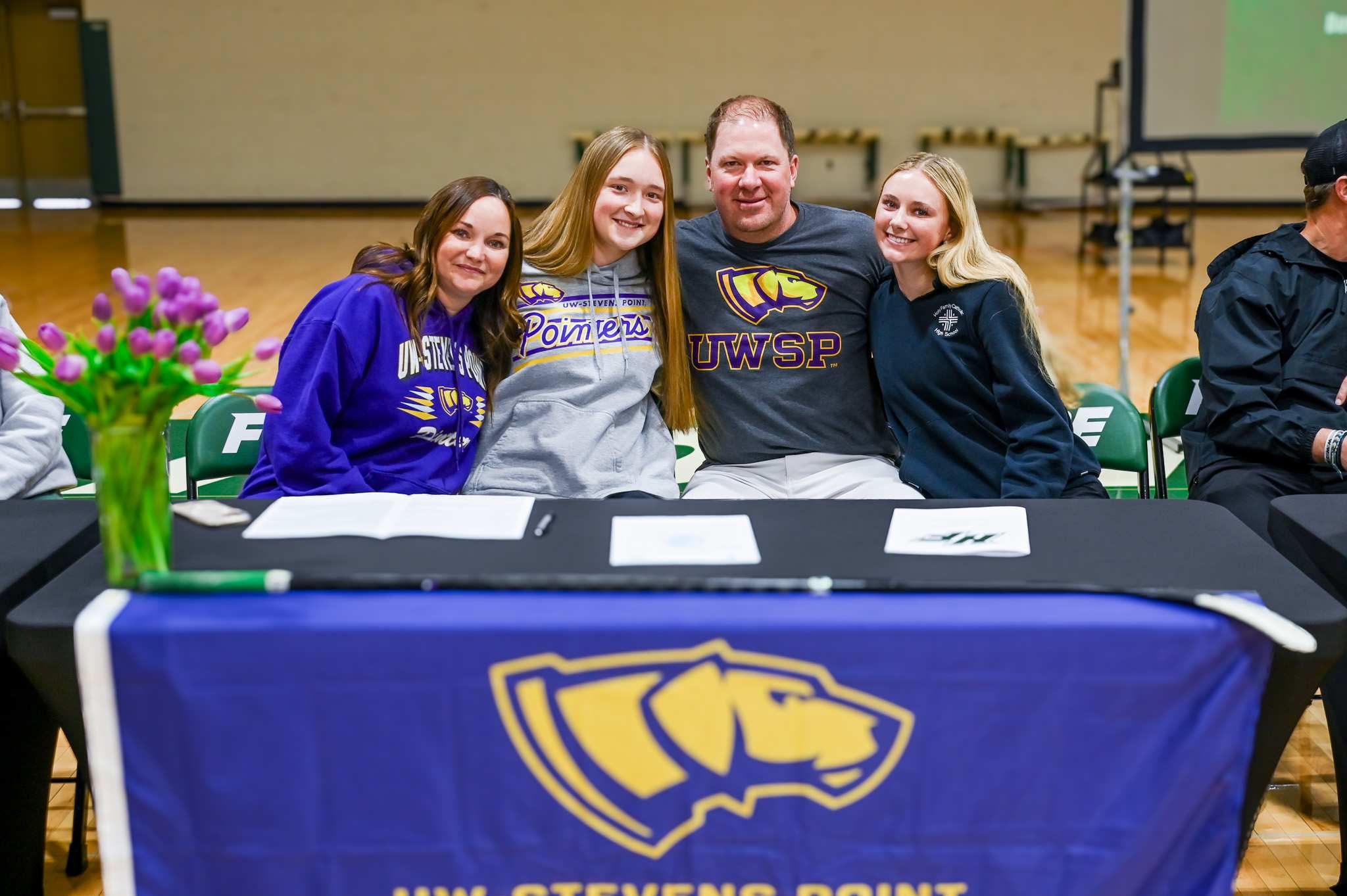 Holy Family senior Lillian DeFauw signs to play college hockey at the University of Wisconsin-Stevens Point with her family.