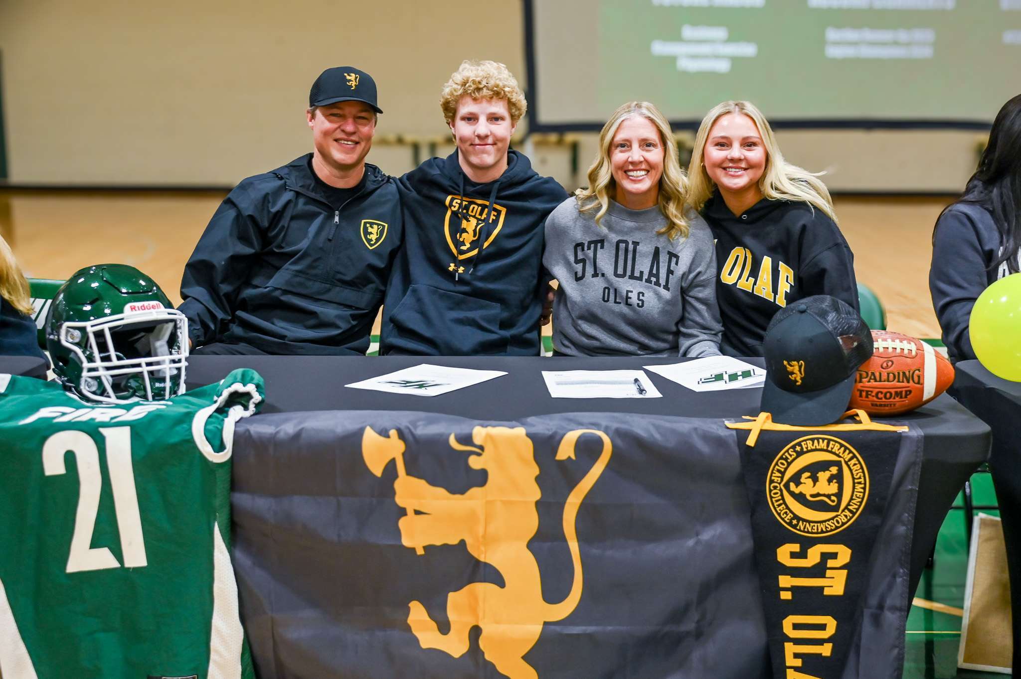 Holy Family senior Noah Galvin signs to continue his football and baseball career at St. Olaf College with his family.