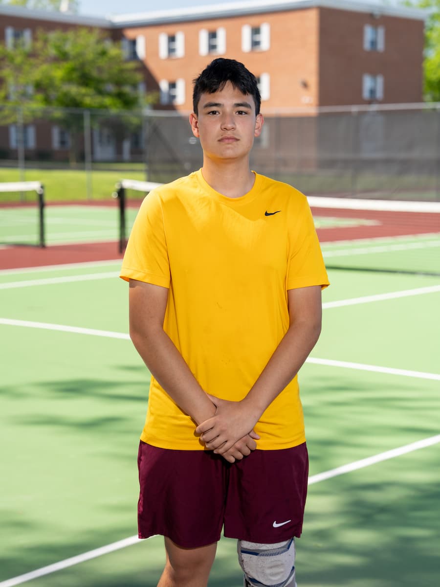Cadet Reyes in his tennis uniform on the tennis court.