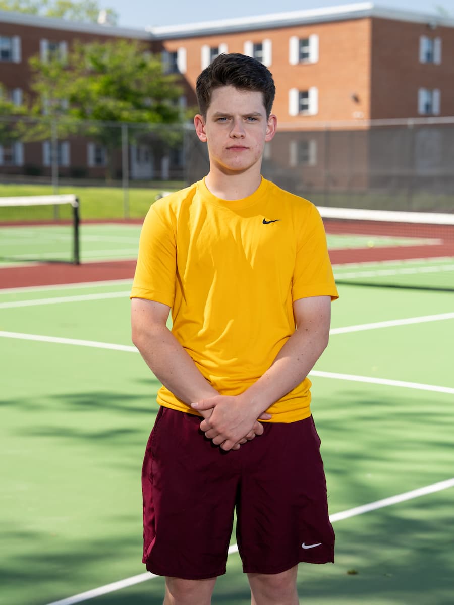 Cadet Scribner in his tennis uniform on the tennis court.