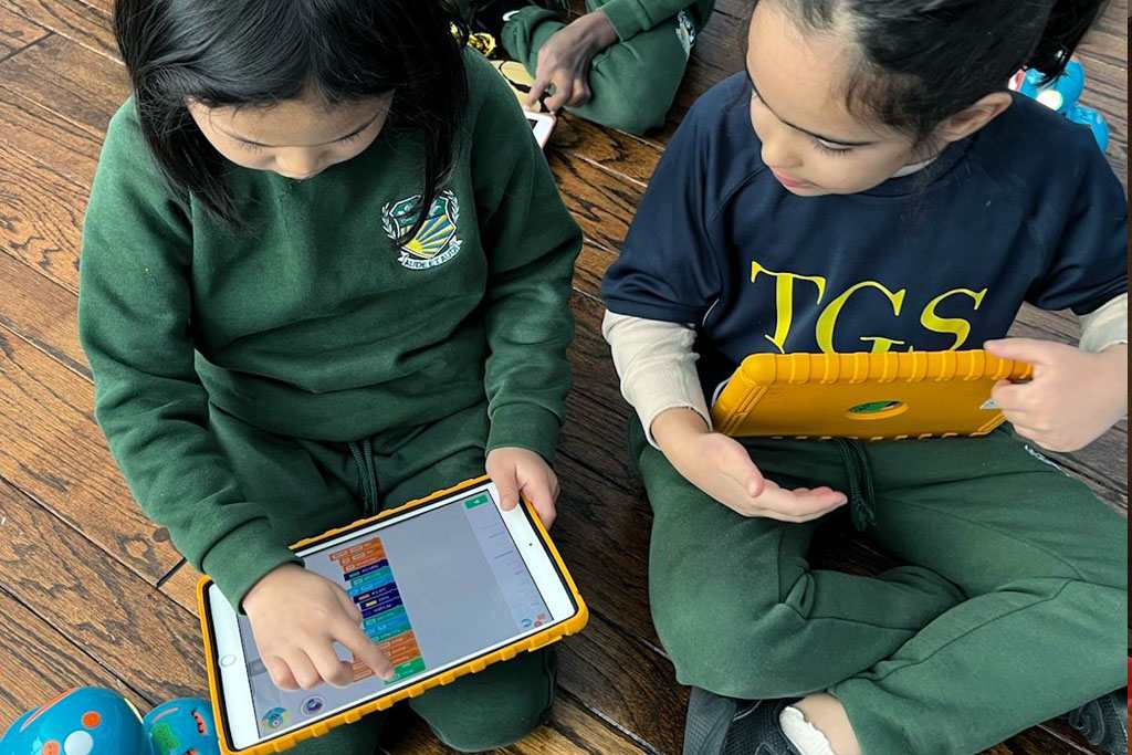 Giles School students coding on tablets