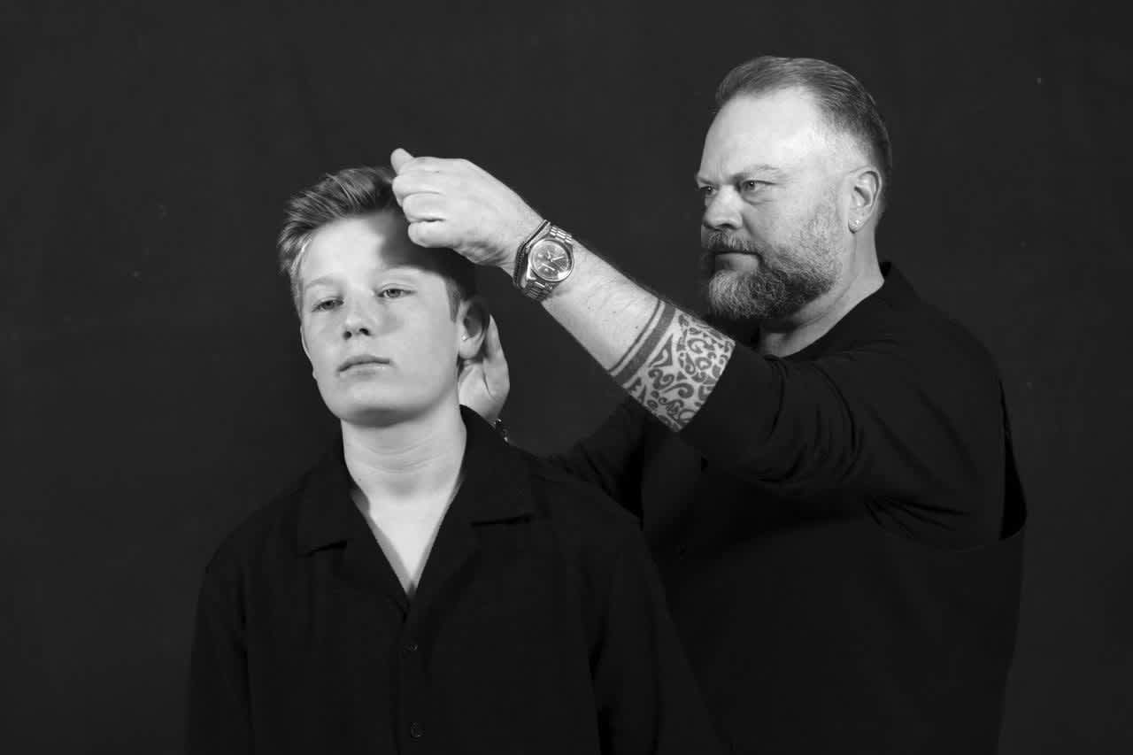 A stylist works with a student during a Sartoria portrait session