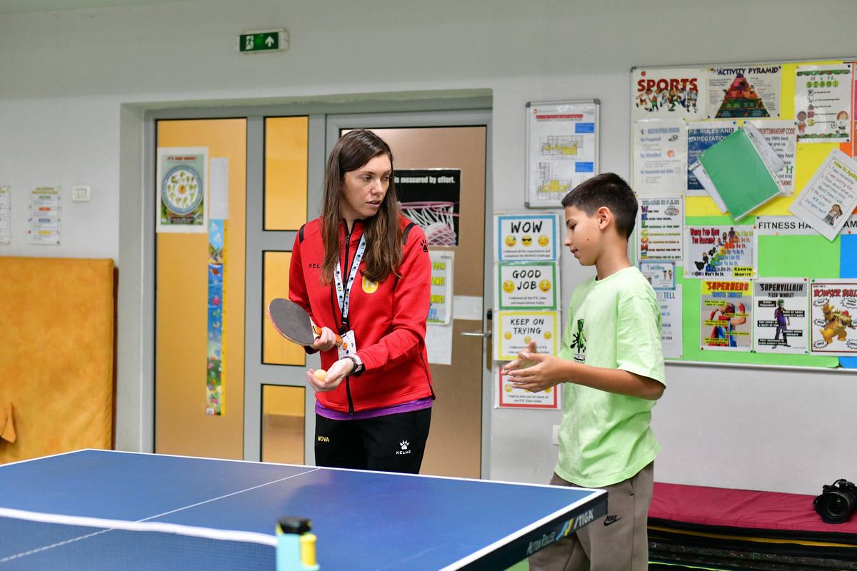 A NOVA coach giving a secondary student personal athletics coaching