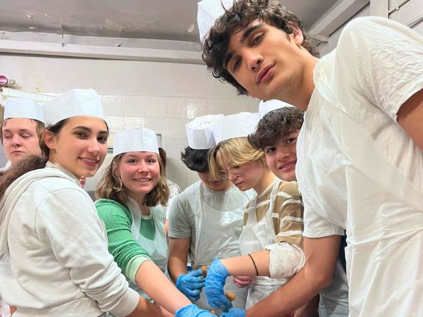 CCI students gathered around a work surface during Cucina