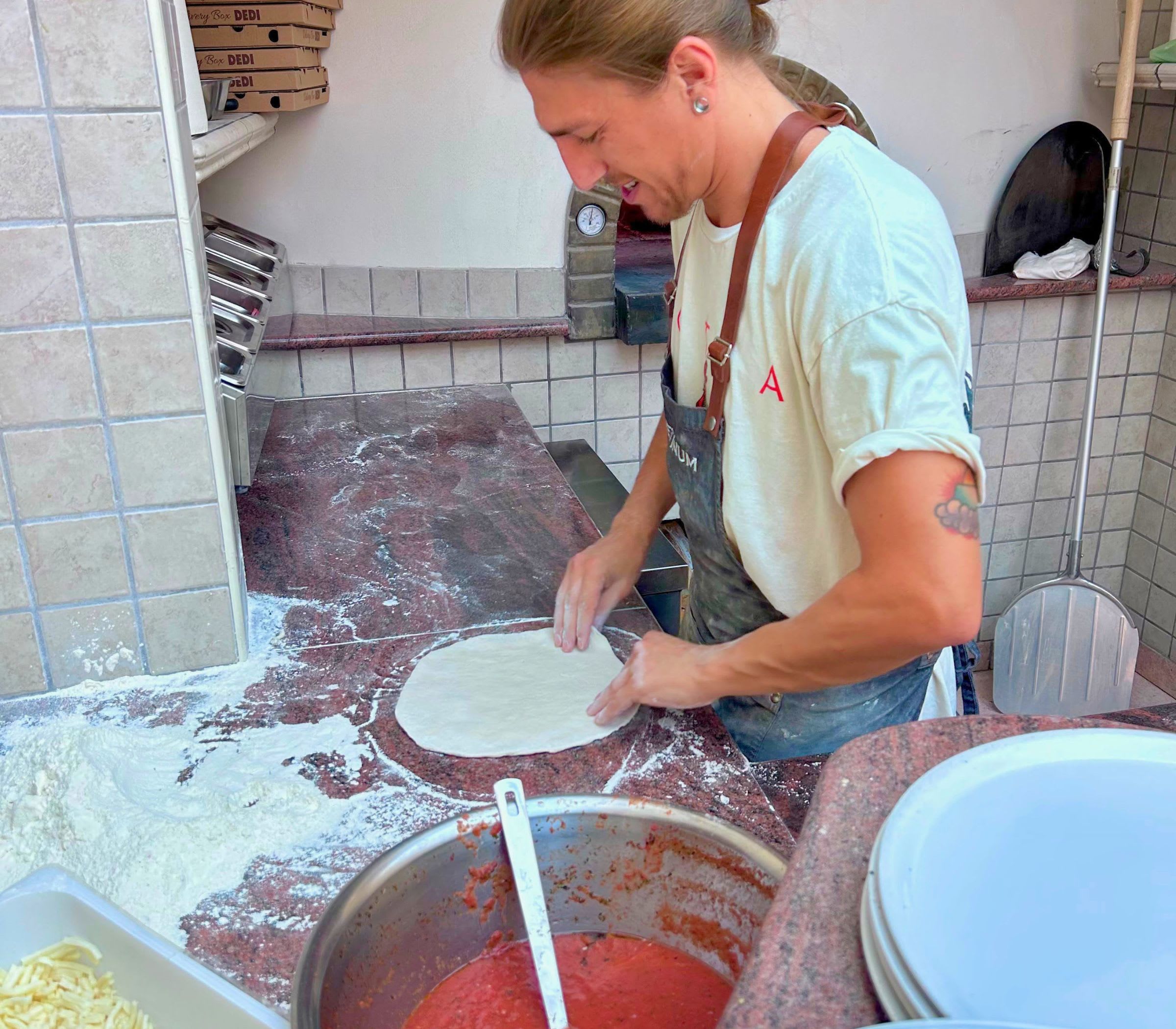 Fresh pizza dough being shaped in Allegria's kitchen
