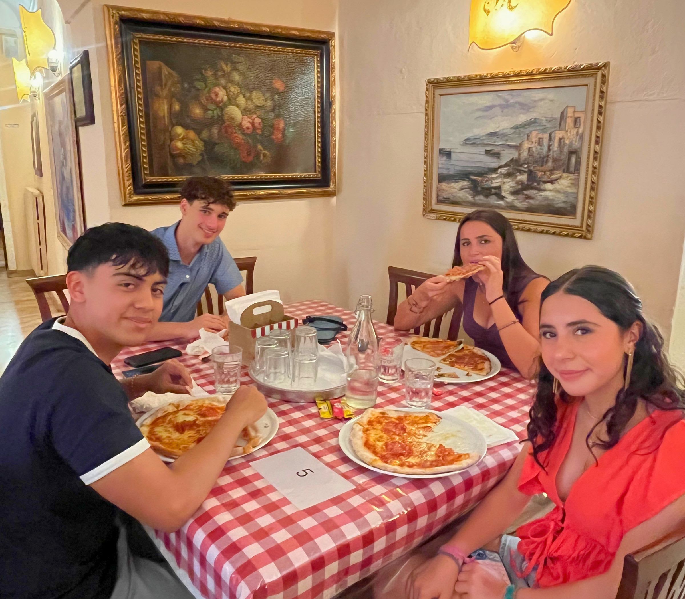 CCI students sharing pizzas around a table in Allegria