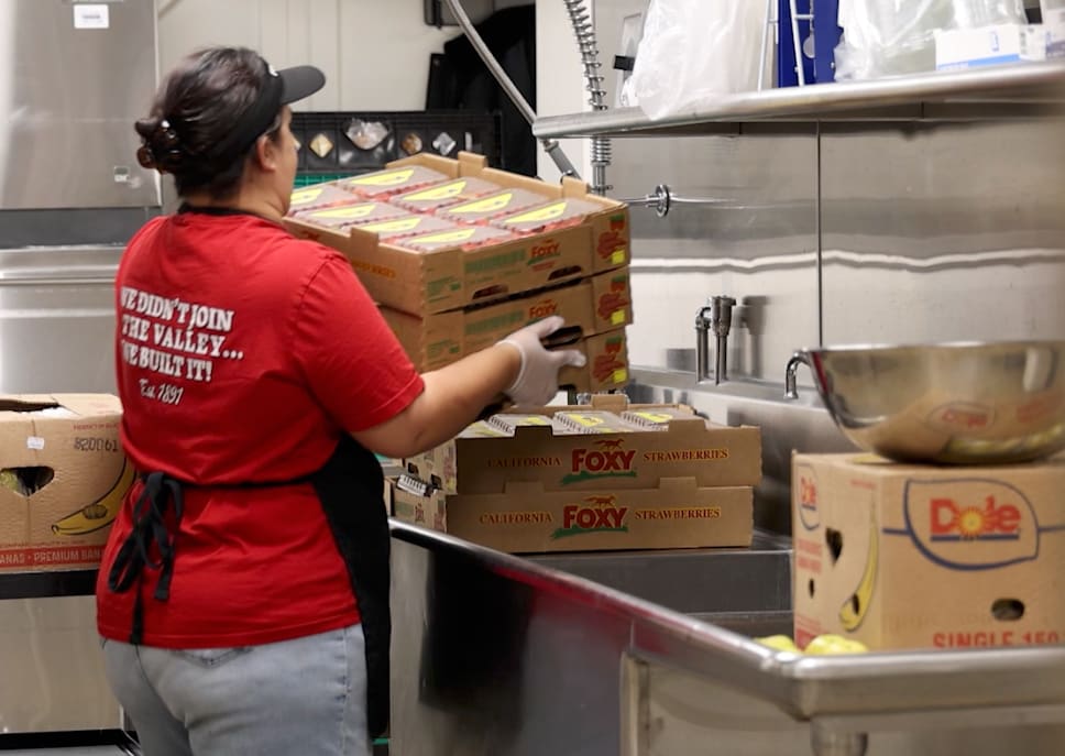 LEUSD Food Services staff prepare a school cafeteria for the morning, following food safety procedures and stocking breakfast items before students arrive.