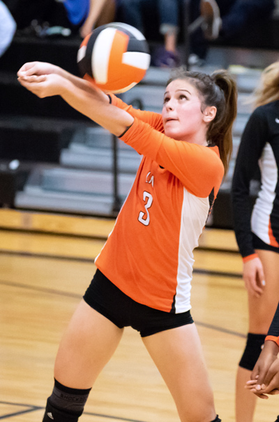 LFA Varsity girls volleyball player volleying the ball upward
