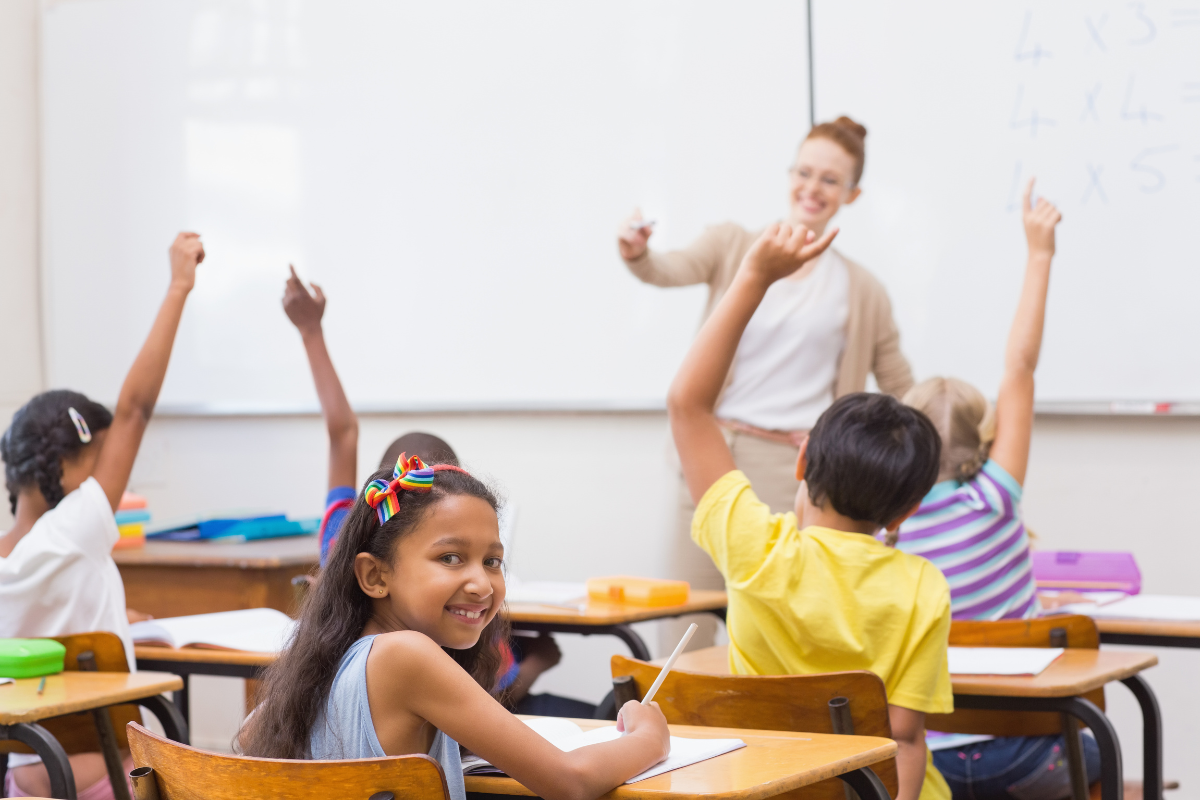 Teach them. Негр поднимает руку в классе. Ученик поднимает руку картинки Сток. Girl at the Classroom raising his hand. One Kid at the Classroom raising his hand.