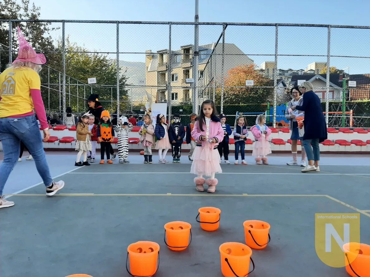 Children playing a bucket toss game at the Elementary fall festival