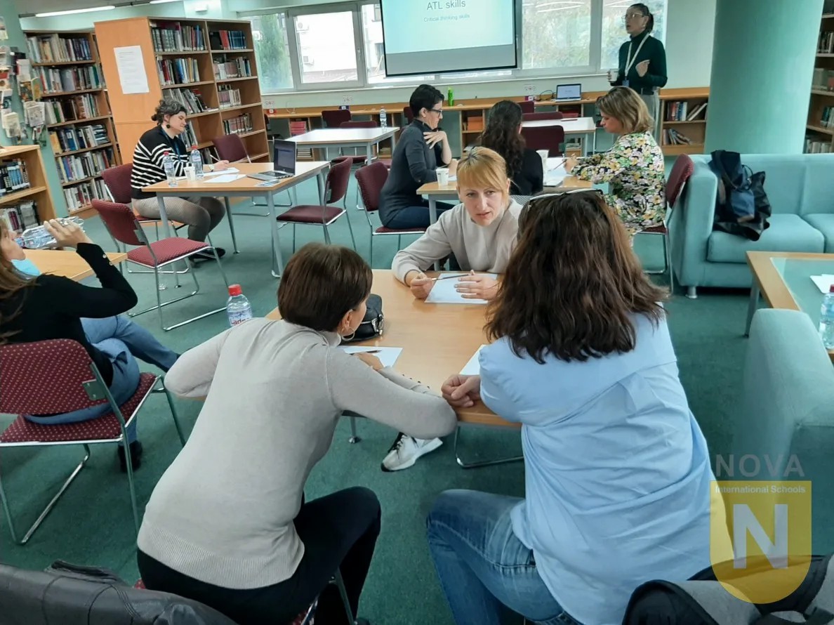 Parents working at tables in the library during a PTA coffee hour on ATL skills