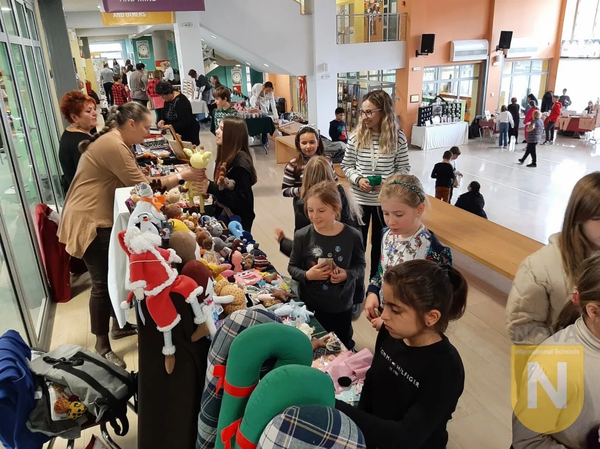 Families browsing handmade crafts at the PTA winter market