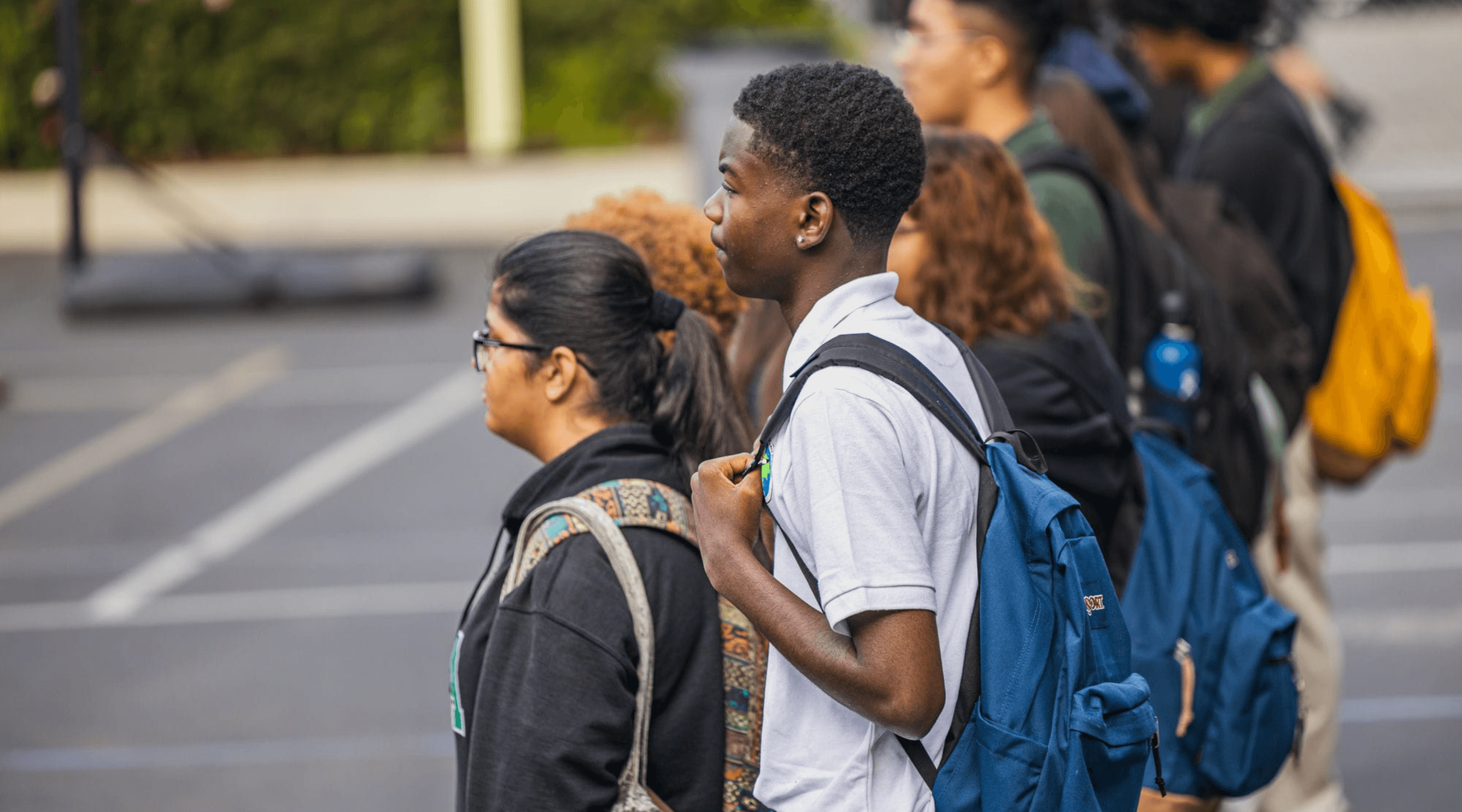 A student stands on the pavement during the first day of school at HMSA.