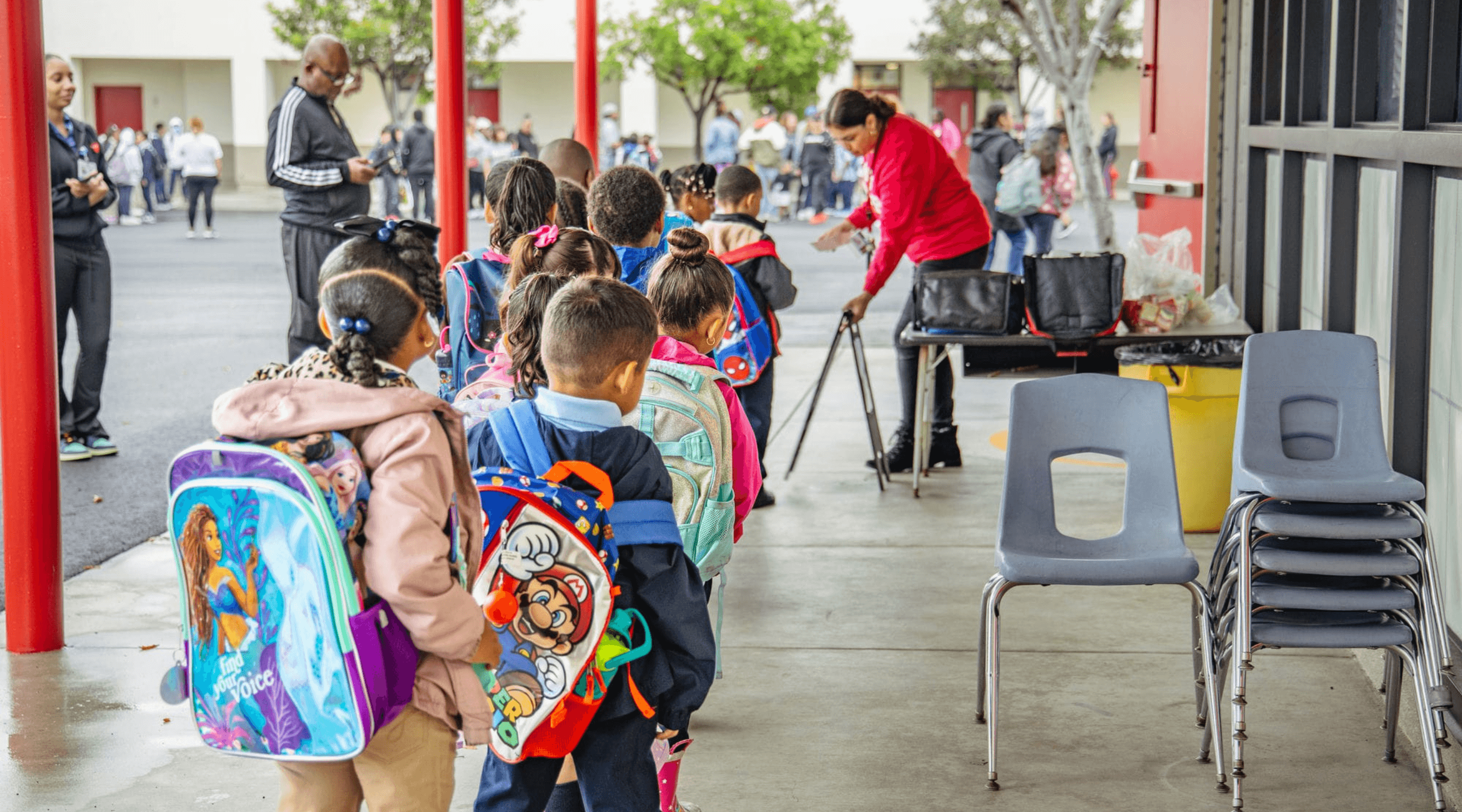 Students line up to enter a classroom on the first day of school.
