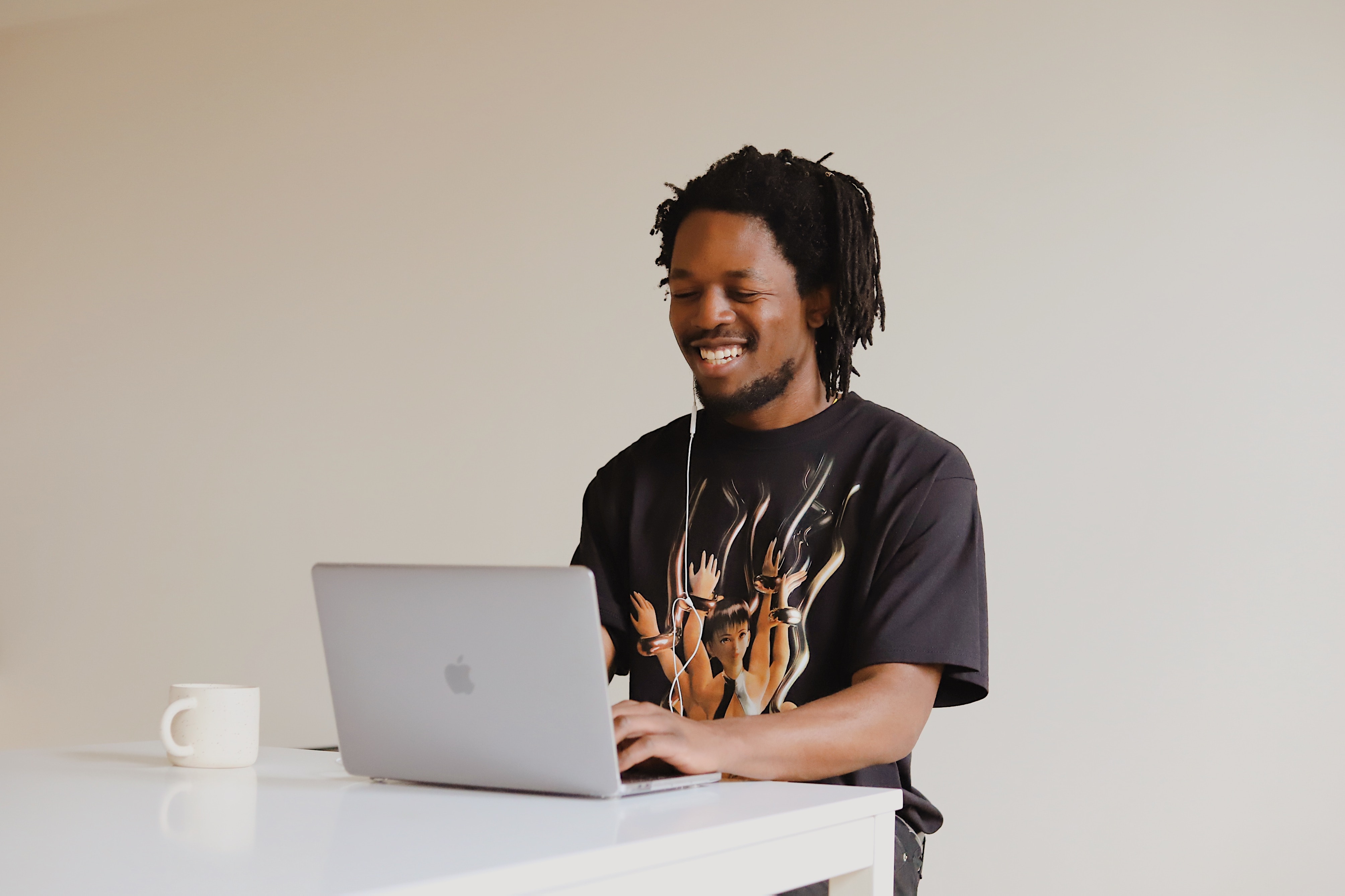 man smiling while working on laptop