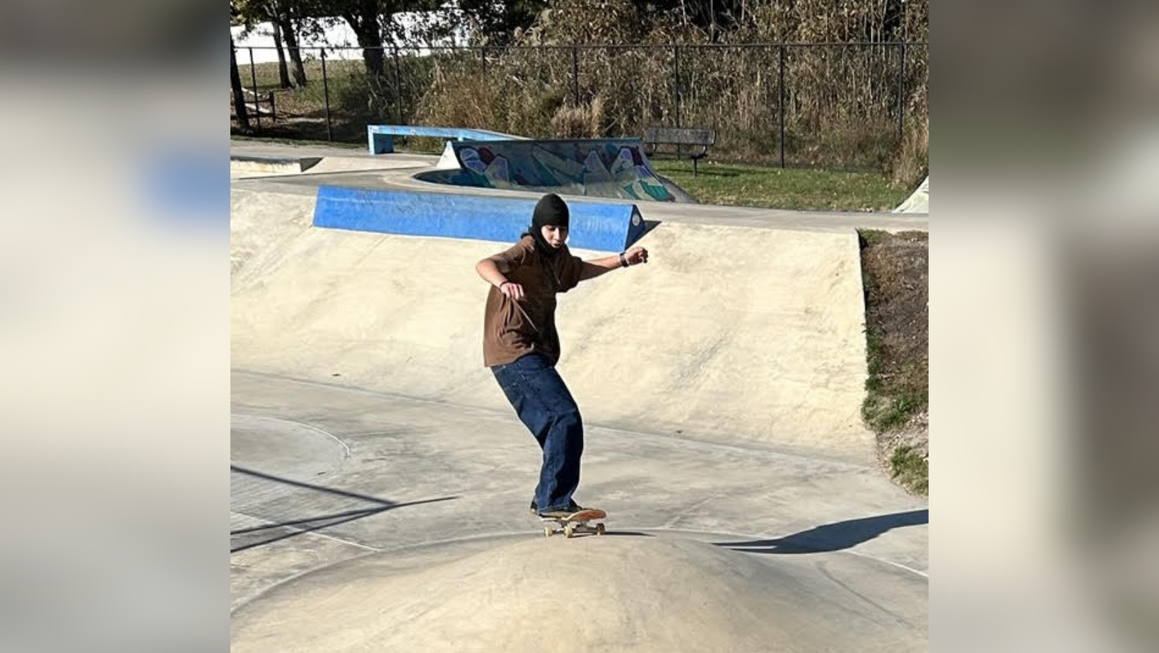Student Skateboarding in a skate park
