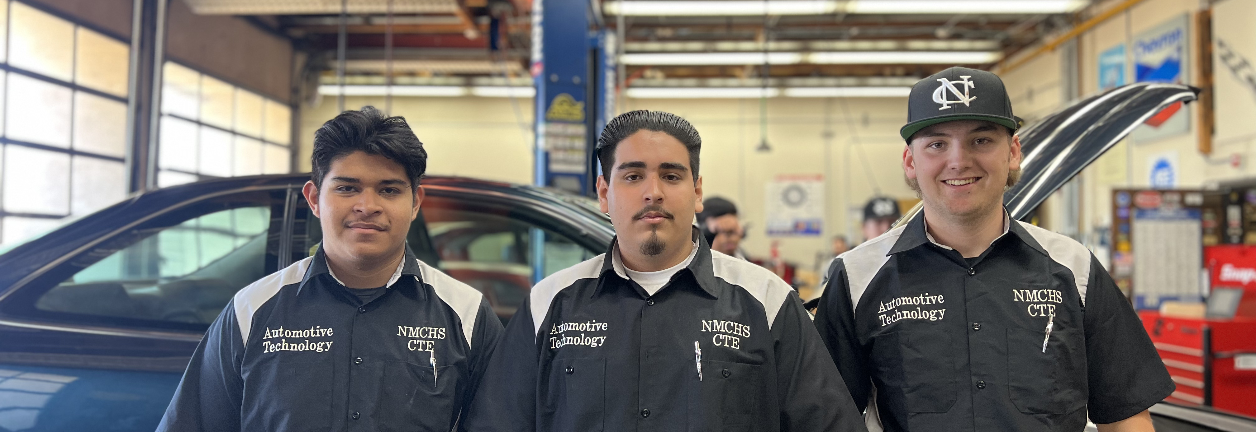 image of automotive students in auto body shop