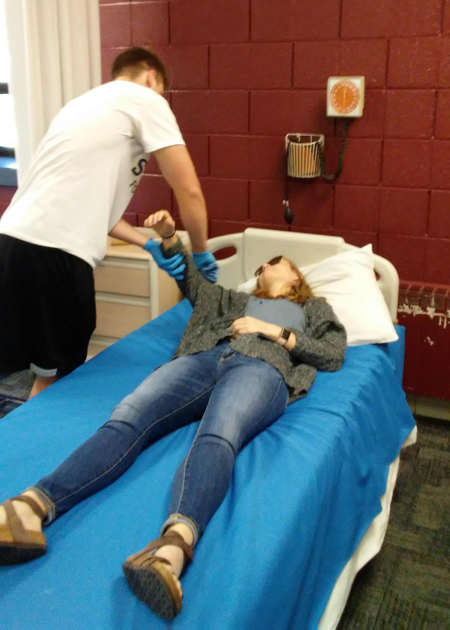 Student checking blood pressure
