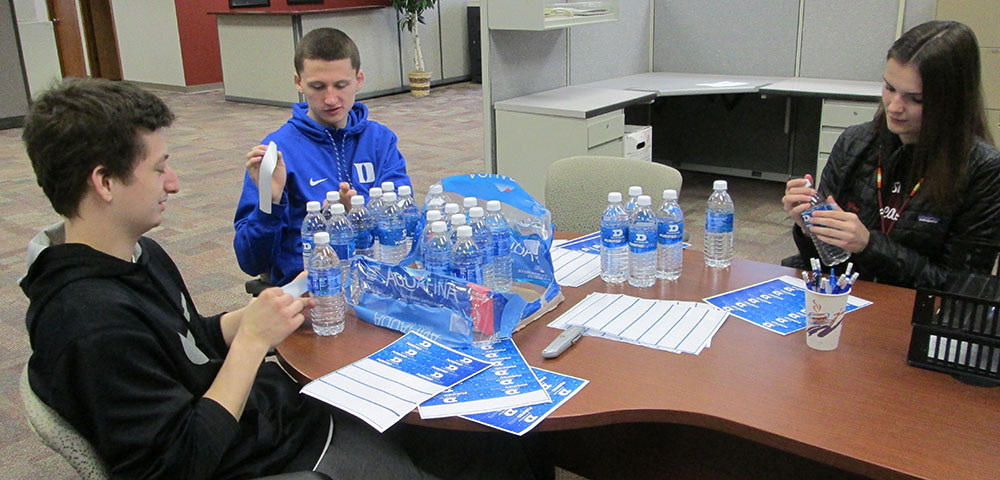 Students sitting at table with water bottles