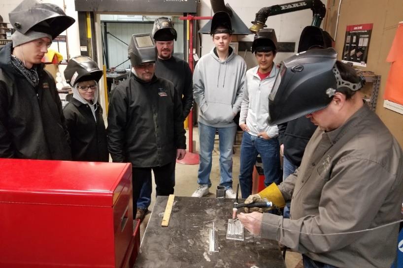 Students learning to weld