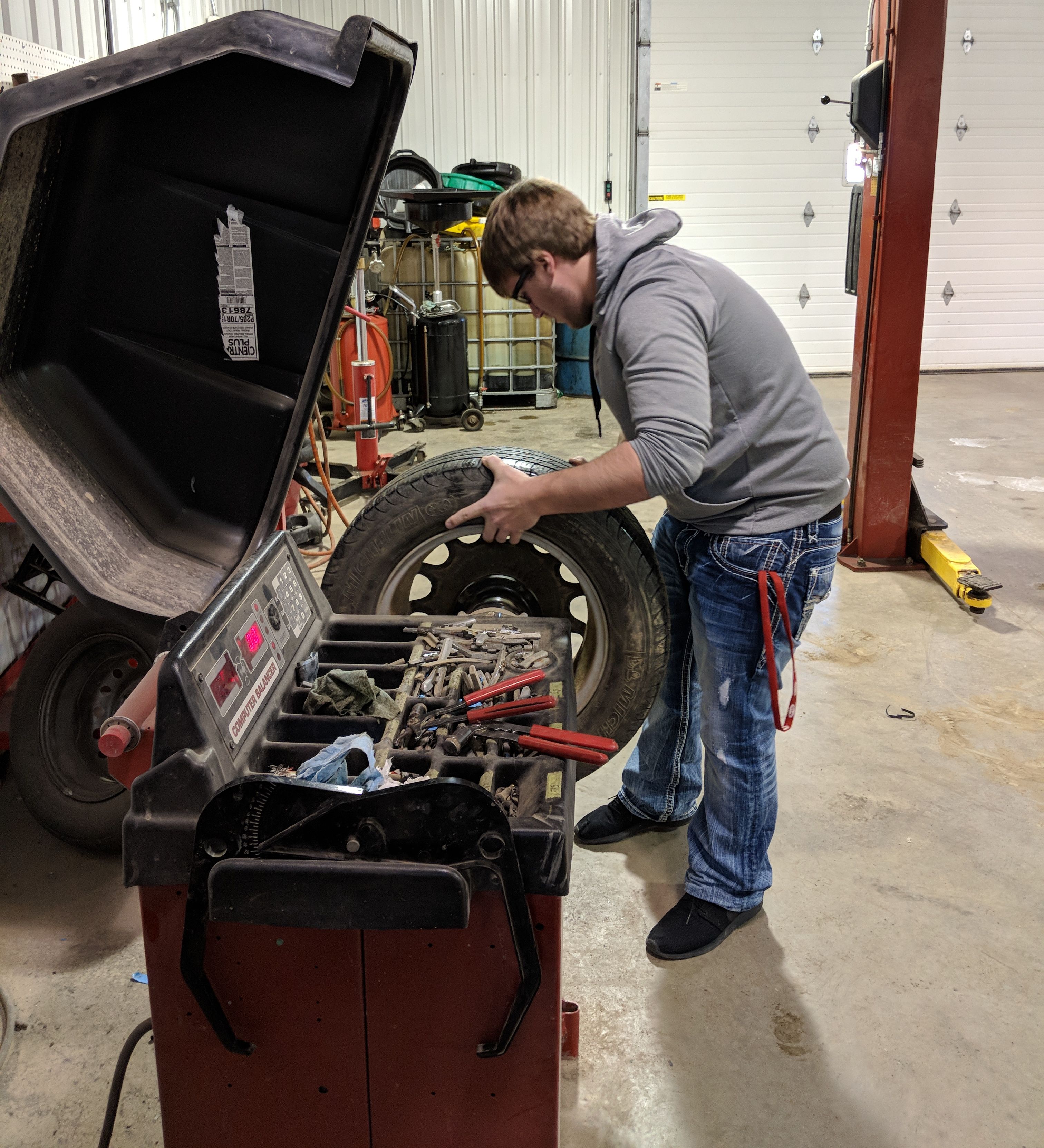 Student moving a tire