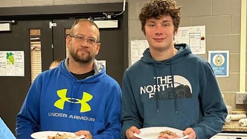 Student and Staff sharing Thanksgiving Meal