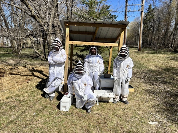 Students with a bee house