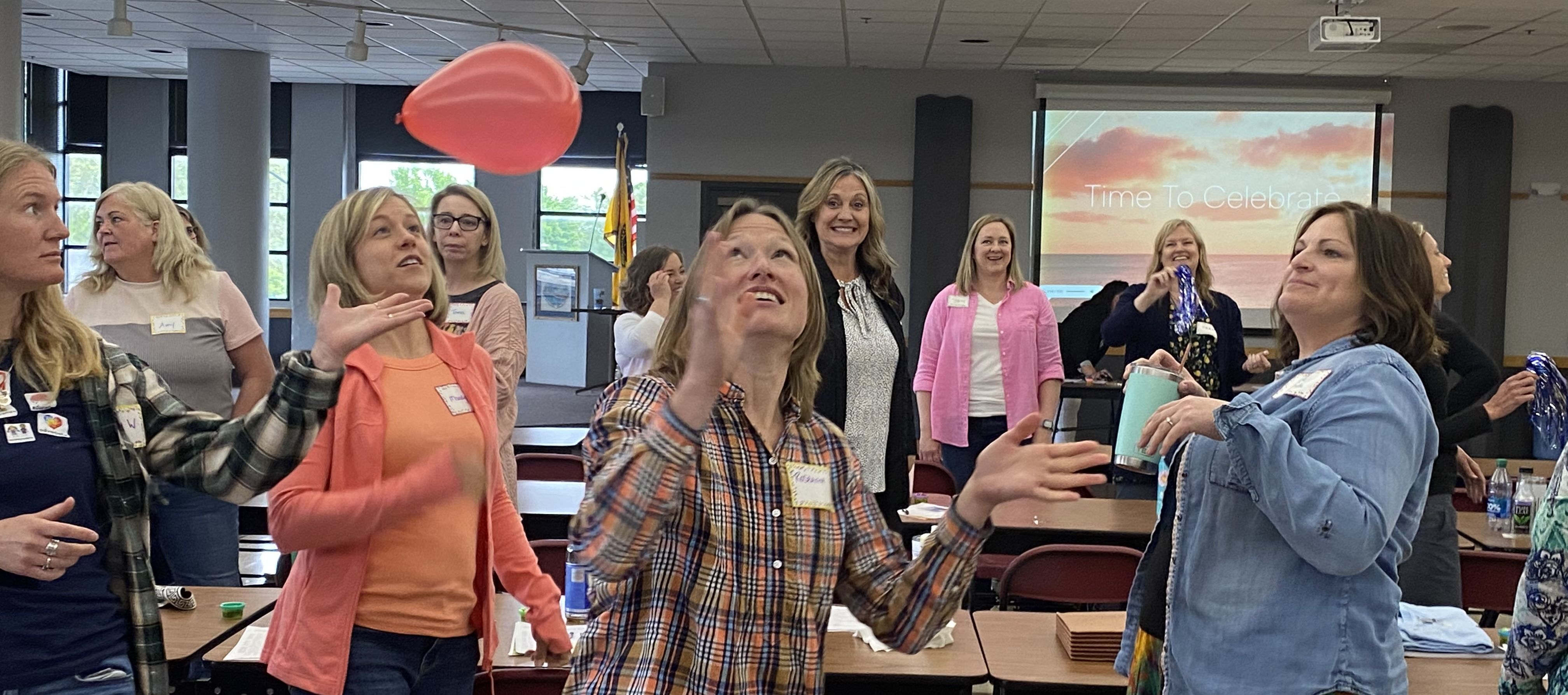 Staff hitting balloon into the air at SPED end of year