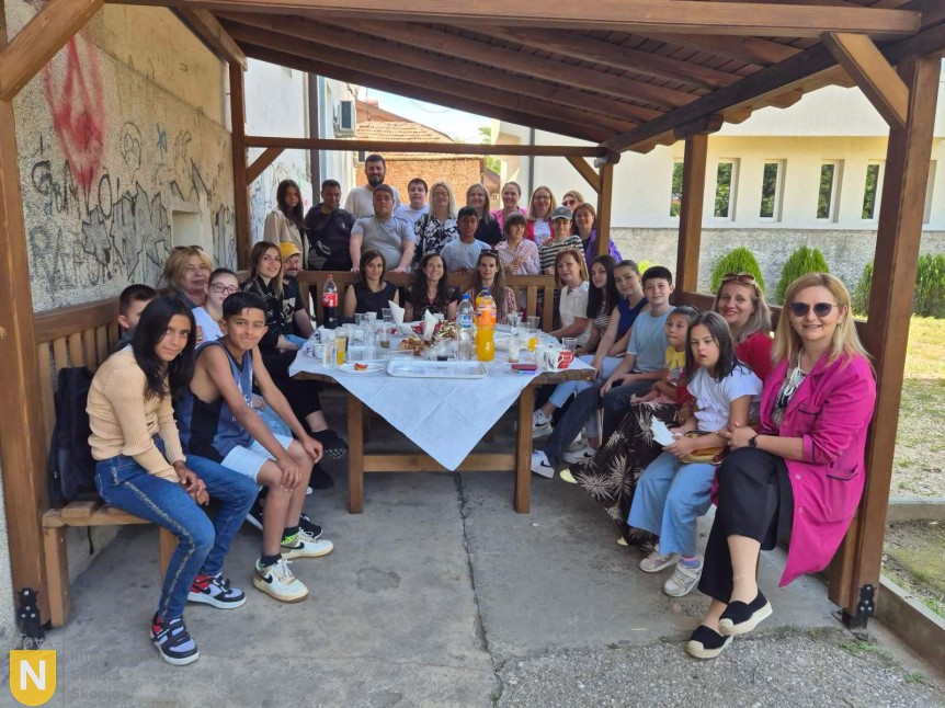 Visitors and hosts sharing refreshments under a covered patio
