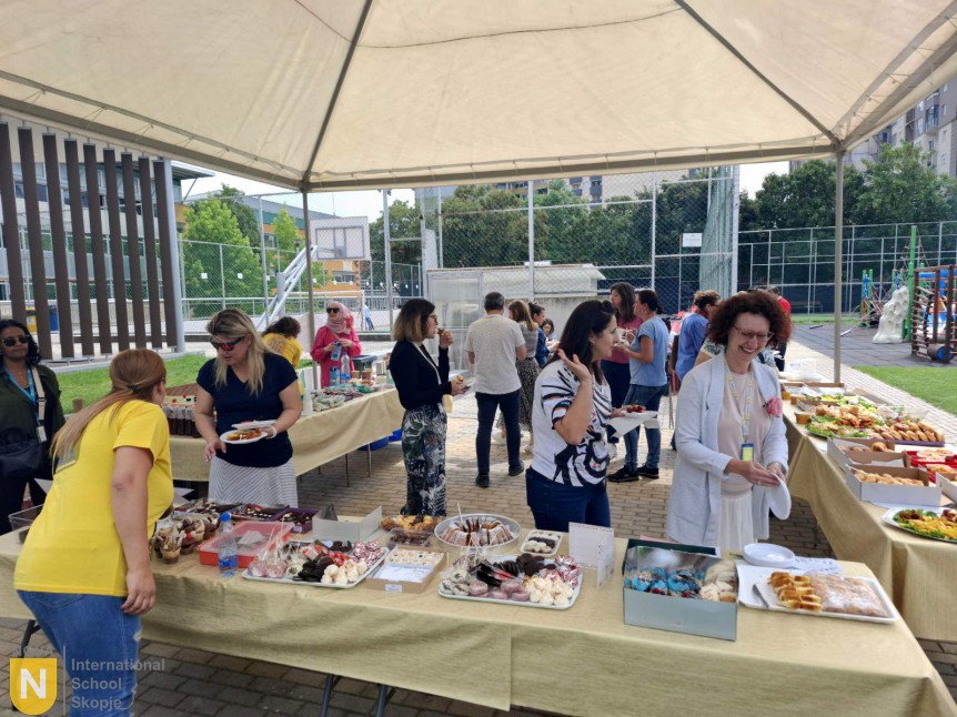 Tables of food set out under a tent for Teacher Appreciation Day