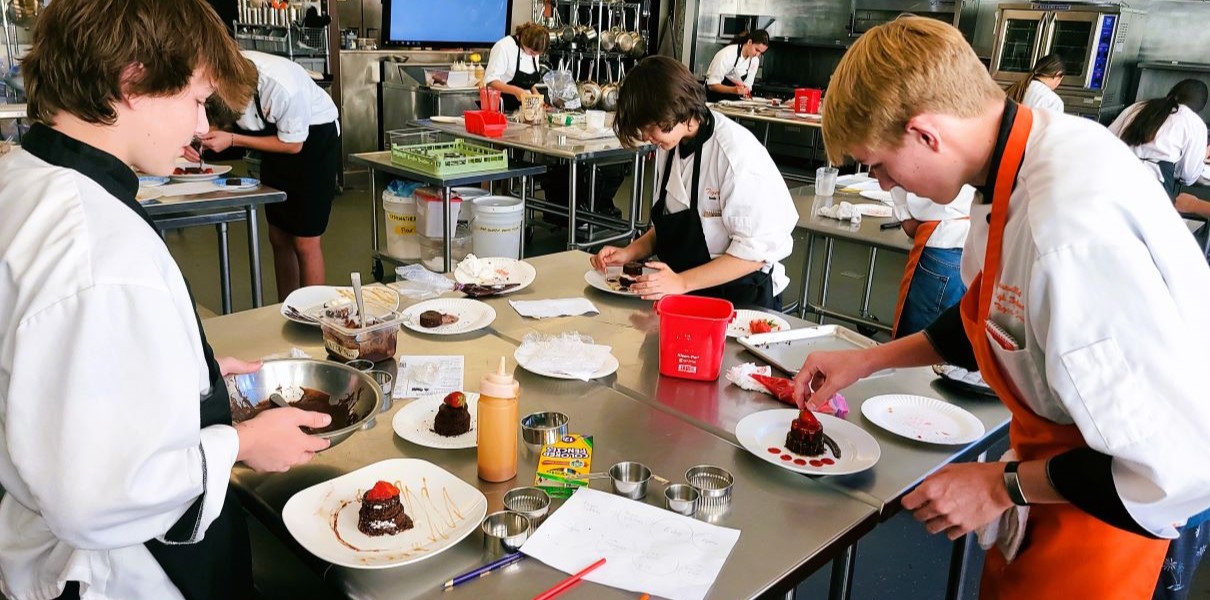 a groups of students work in the culinary CTE program at Roseville High School