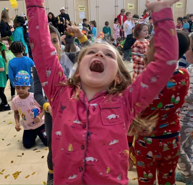 girl with arms in air, cheering