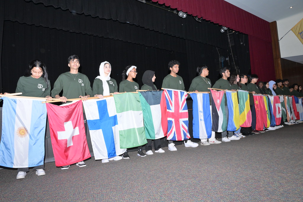 students with banners of international flags