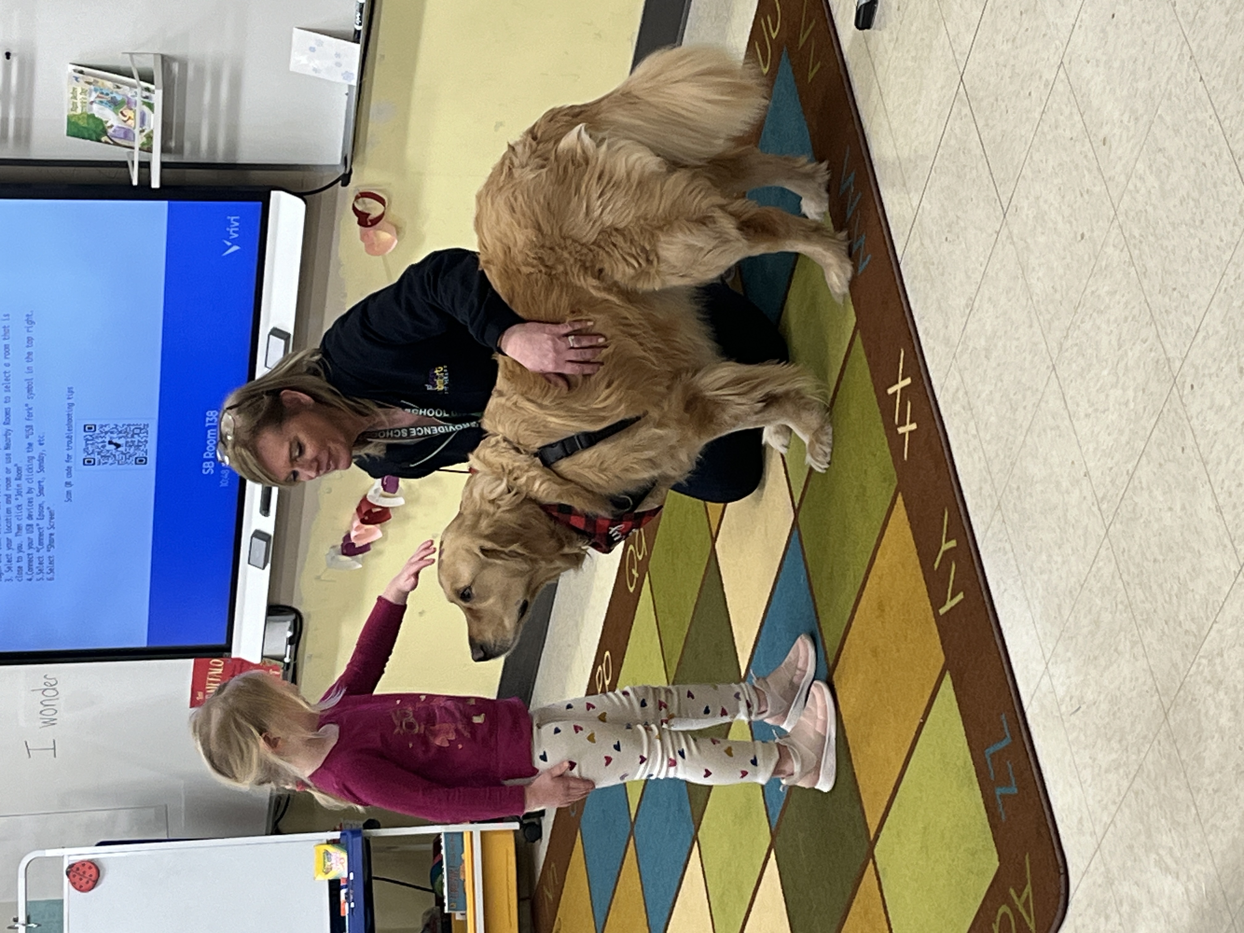 Bailey the therapy dog with students at Salt Brook