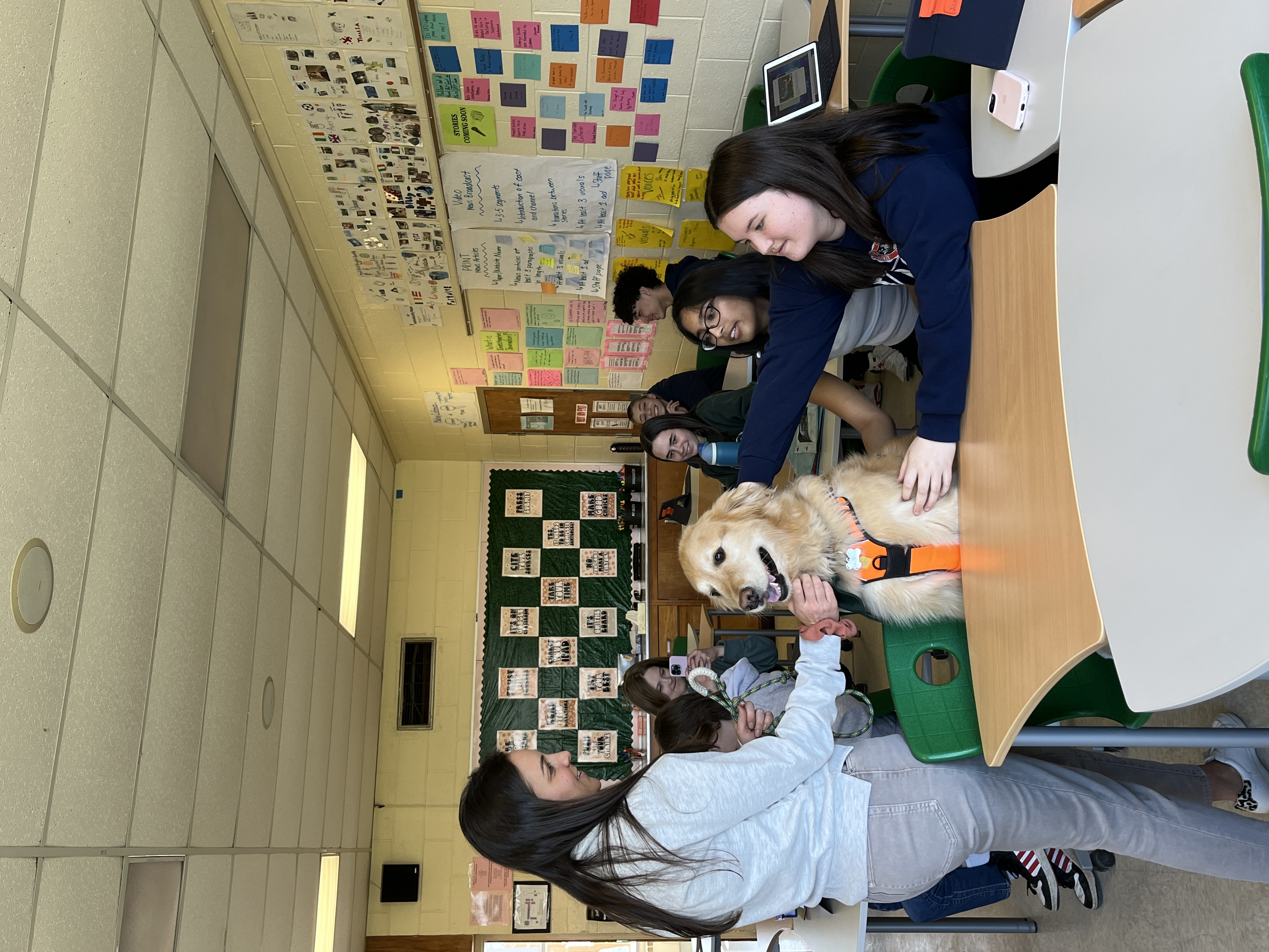 Finny the  therapy dog with students at NPMS